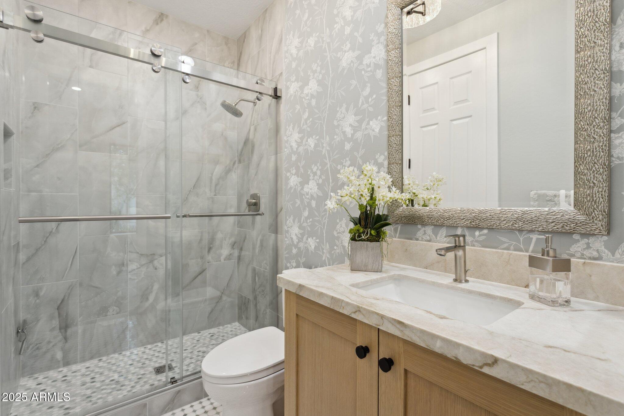 9270 East Thompson Peak Parkway, Unit 364 Scottsdale, AZ 85255 - Photo 21 of 45 a bathroom with a granite countertop sink a toilet and shower