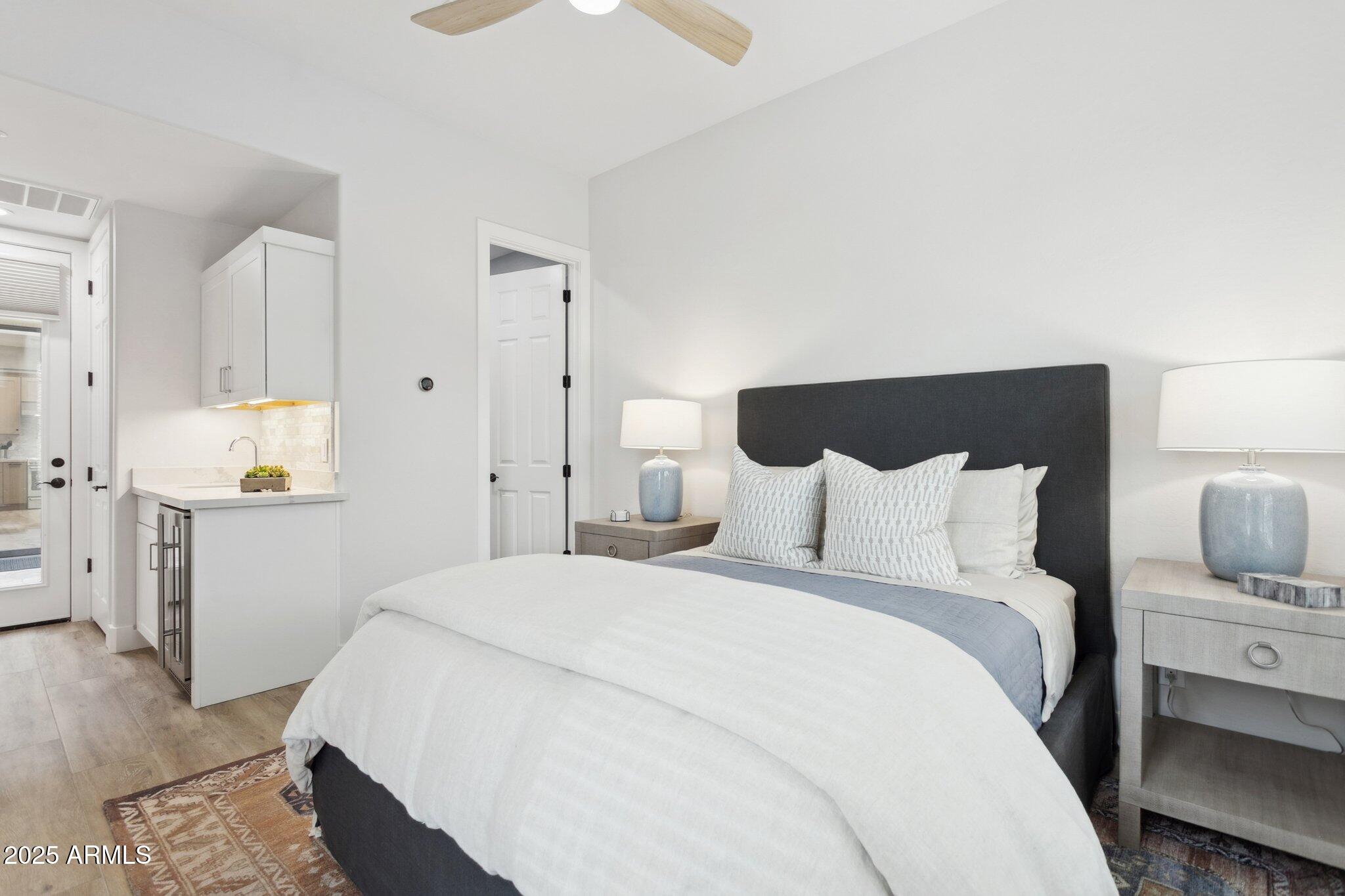 9270 East Thompson Peak Parkway, Unit 364 Scottsdale, AZ 85255 - Photo 24 of 45 a bedroom with a bed and a view of kitchen