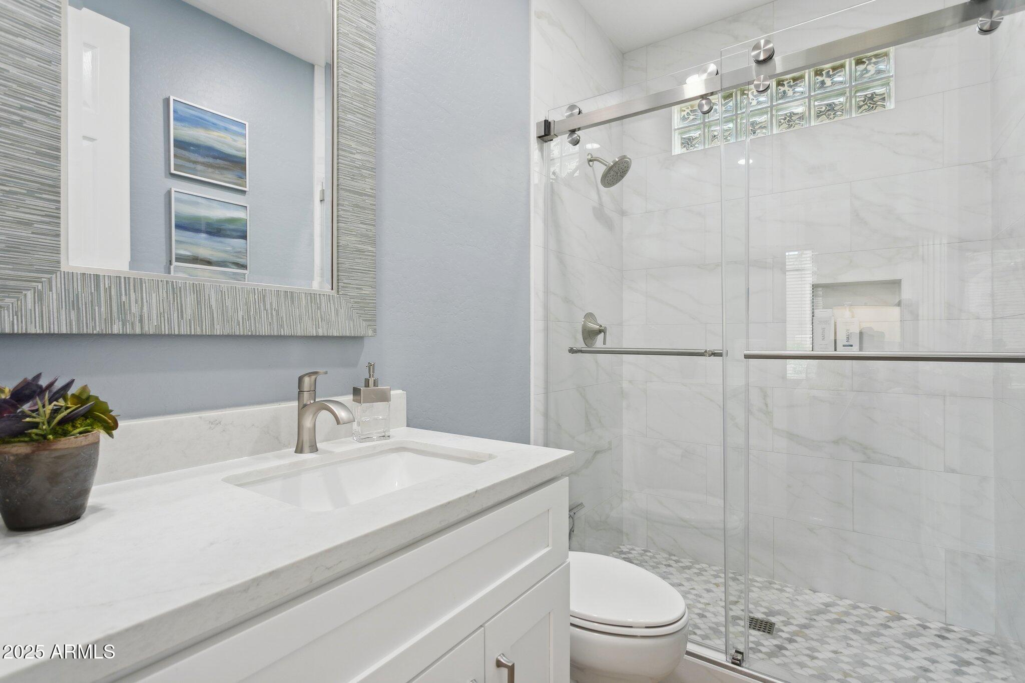 9270 East Thompson Peak Parkway, Unit 364 Scottsdale, AZ 85255 - Photo 26 of 45 a bathroom with a sink a toilet and shower