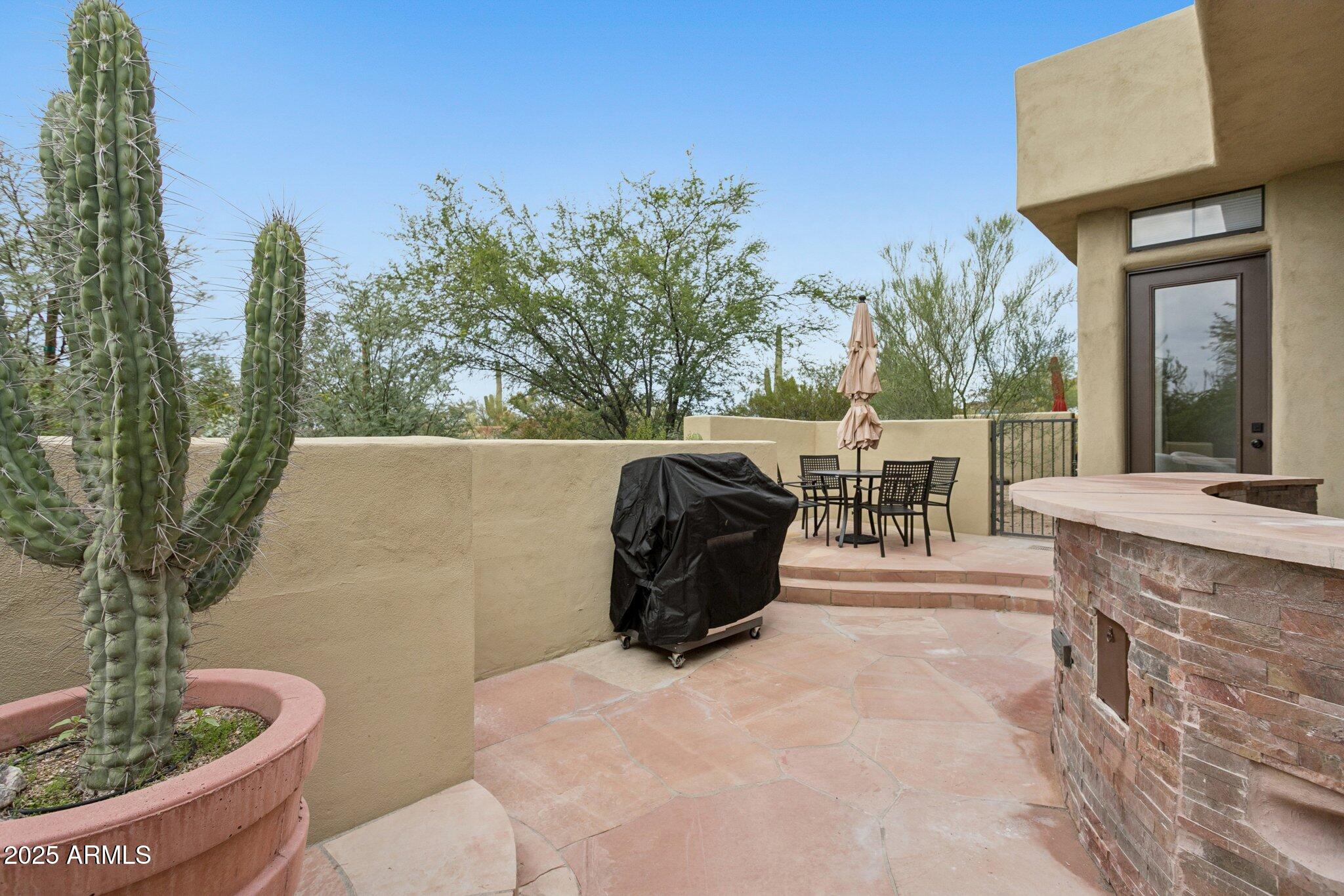 9270 East Thompson Peak Parkway, Unit 364 Scottsdale, AZ 85255 - Photo 30 of 45 a balcony with table and chairs