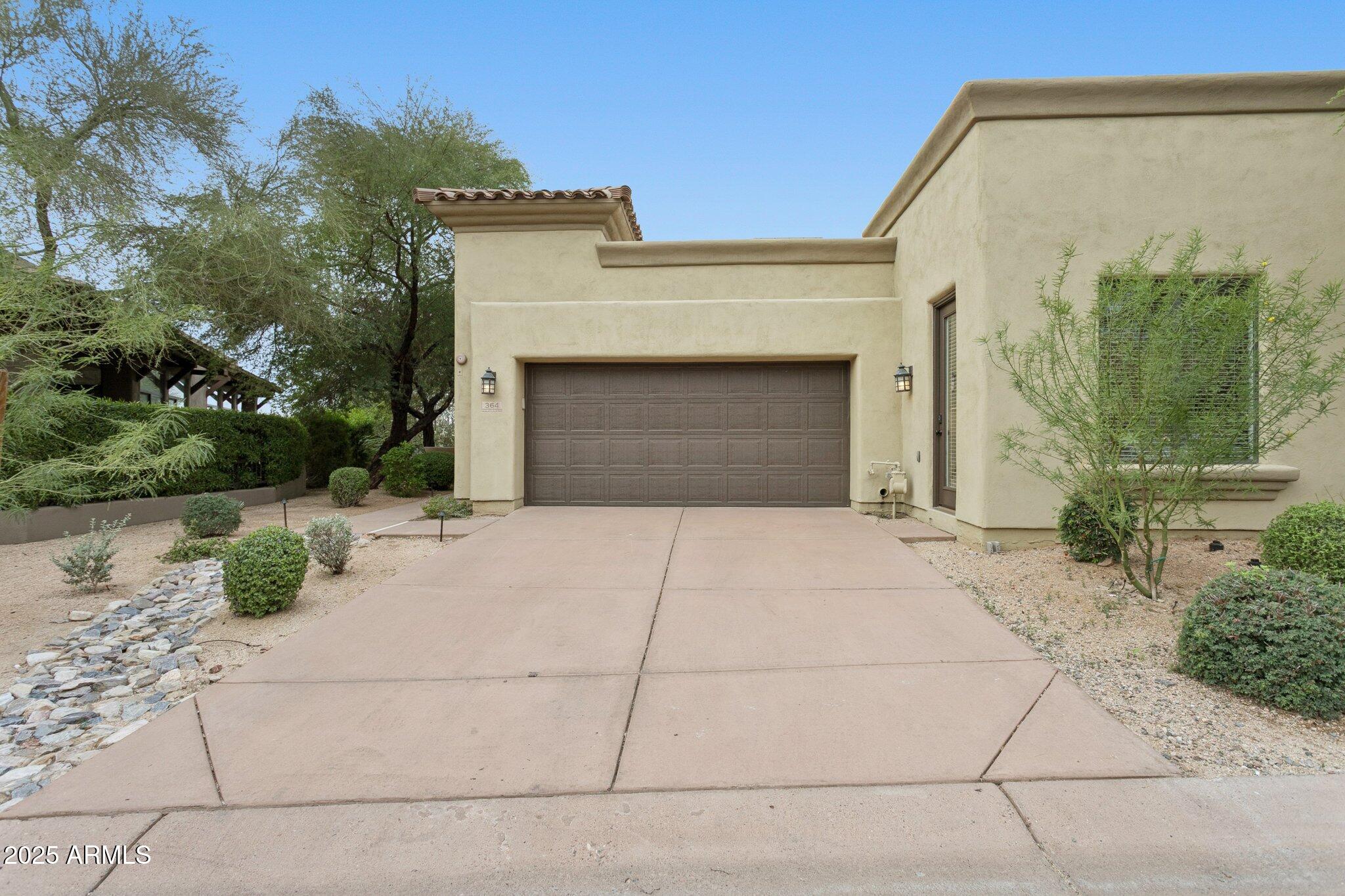 9270 East Thompson Peak Parkway, Unit 364 Scottsdale, AZ 85255 - Photo 31 of 45 a front view of a house with garden