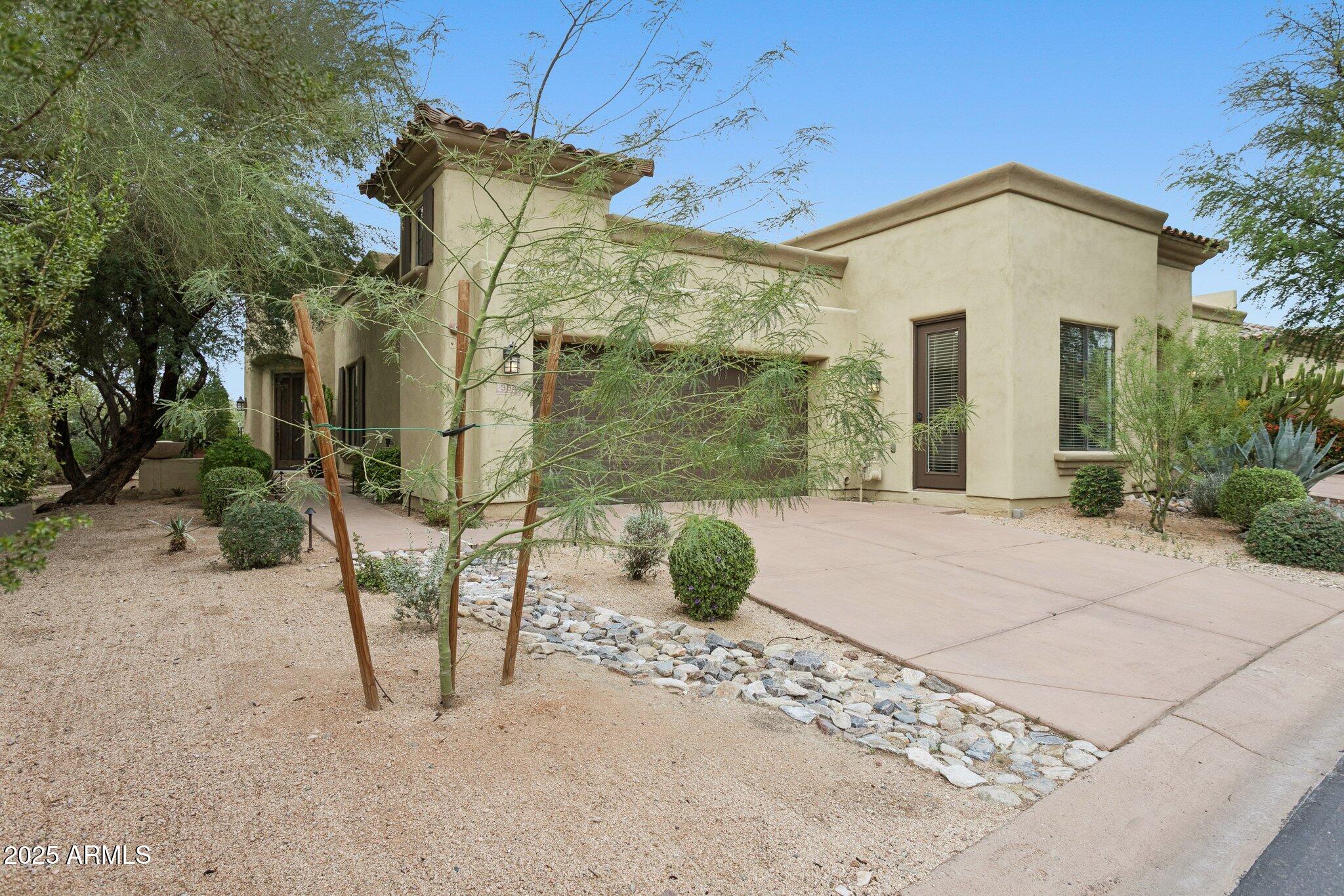 9270 East Thompson Peak Parkway, Unit 364 Scottsdale, AZ 85255 - Photo 4 of 45 a front view of a house with garden