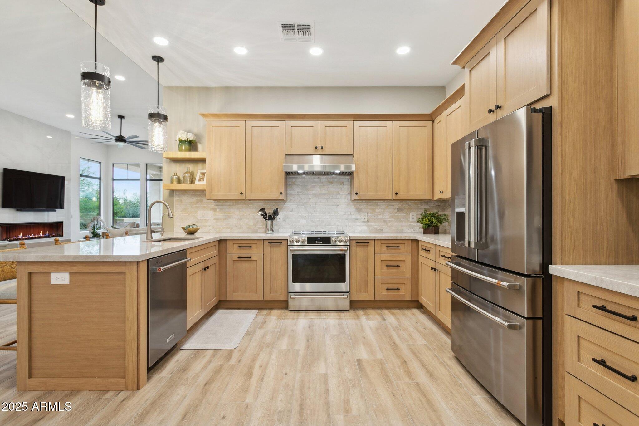 9270 East Thompson Peak Parkway, Unit 364 Scottsdale, AZ 85255 - Photo 9 of 45 a large kitchen with stainless steel appliances granite countertop a stove a sink and a refrigerator