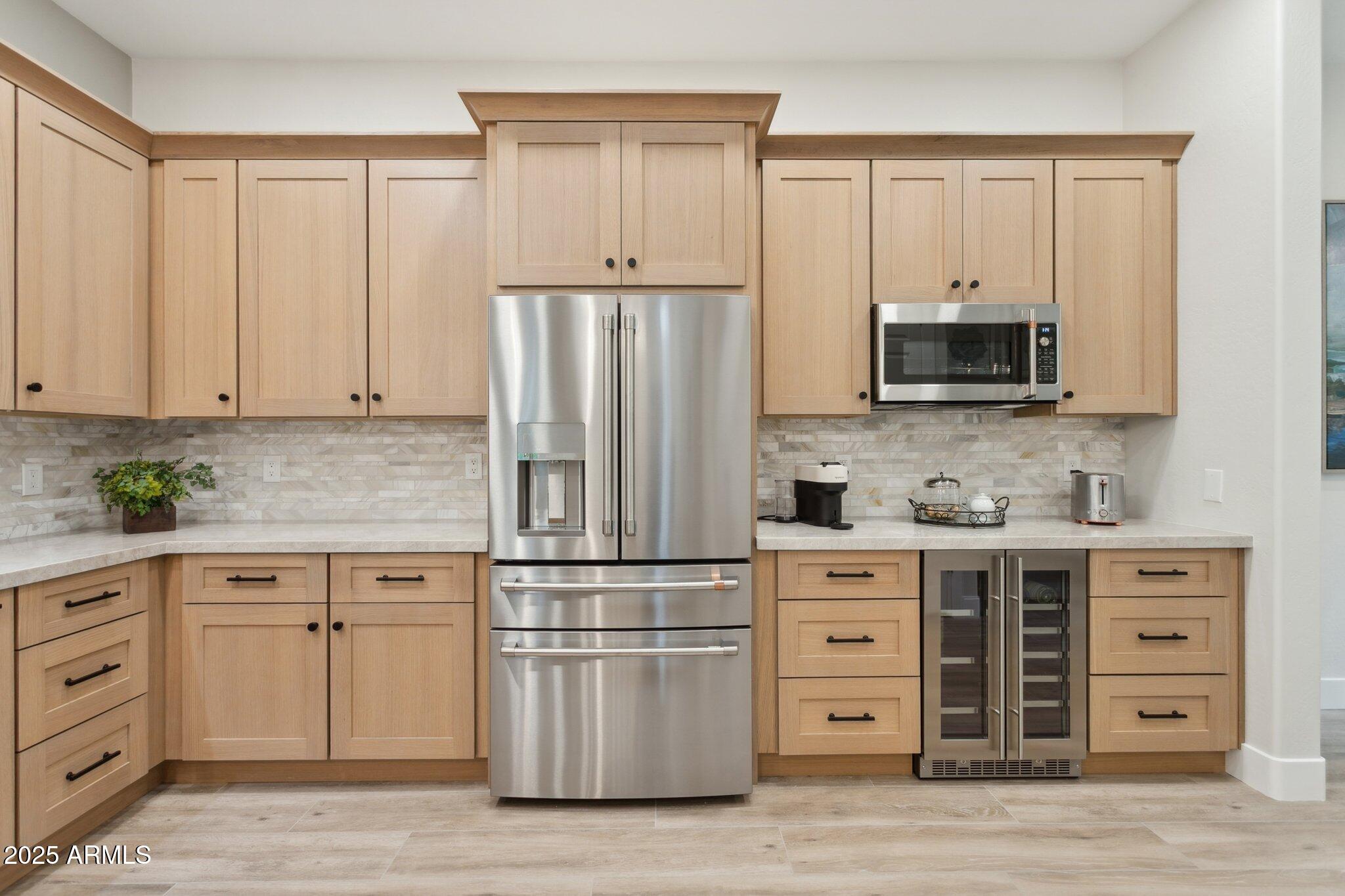 9270 East Thompson Peak Parkway, Unit 364 Scottsdale, AZ 85255 - Photo 10 of 45 a kitchen with cabinets stainless steel appliances and wooden floor