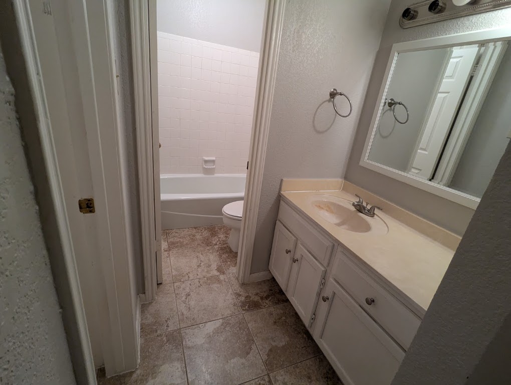 2410 Enfield Road, Unit 5 Austin, TX 78703 - Photo 14 of 17 a bathroom with a sink and a mirror