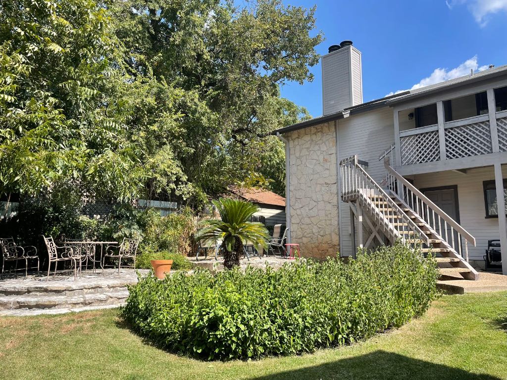 2410 Enfield Road, Unit 5 Austin, TX 78703 - Photo 5 of 17 a front view of a house with garden