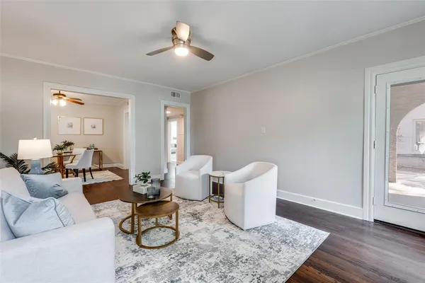 a living room with furniture and wooden floor