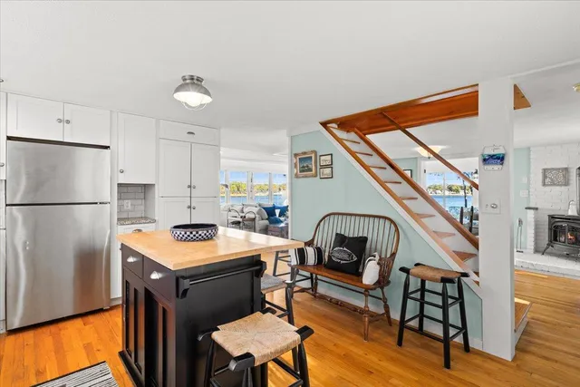a spacious bedroom with a bed and wooden floor