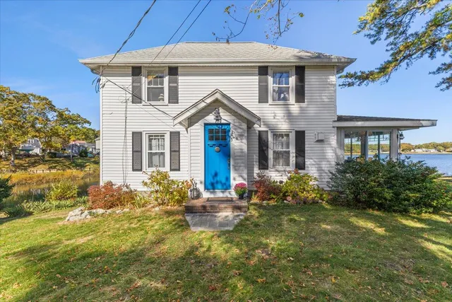 a living room with furniture and large windows
