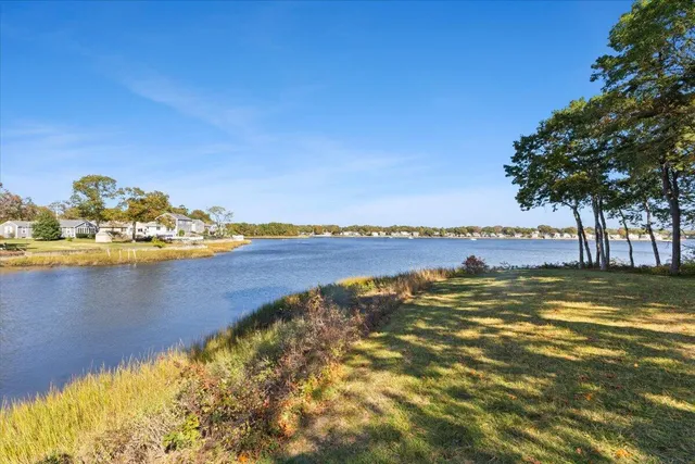 a view of a room with wooden floor and furniture