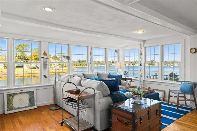 a living room with furniture and large windows