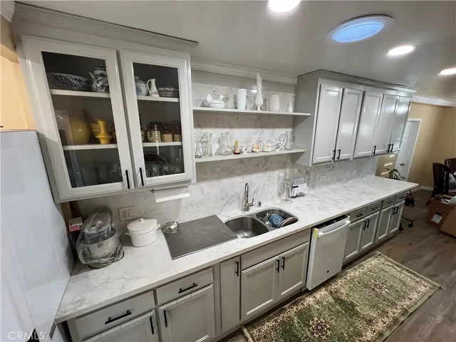 a kitchen with stainless steel appliances granite countertop a sink and cabinets