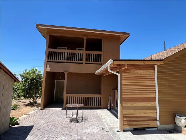 a view of a house with a yard and stairs