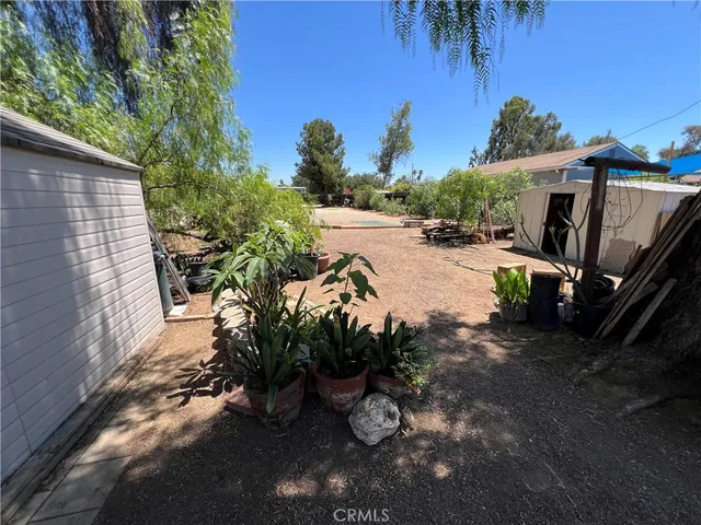 a view of a backyard with swimming pool
