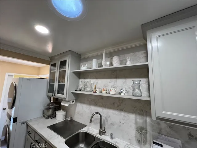 a kitchen with a sink and a stove top oven