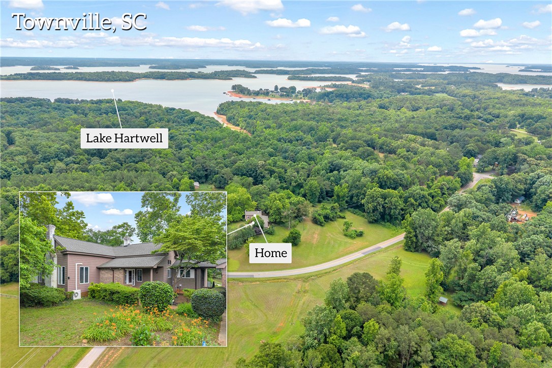 200 Chenault Road Townville, SC 29689 - Photo 1 of 47 An aerial panorama reveals a vast, wooded landscape surrounding a peaceful lake.