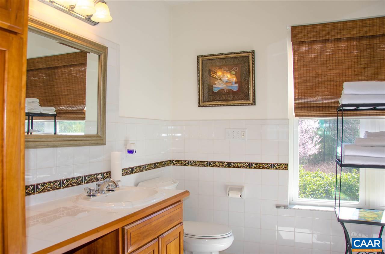 136 Fishpond Road Howardsville, VA 24562 - Photo 12 of 49 a bathroom with a sink a toilet and a window