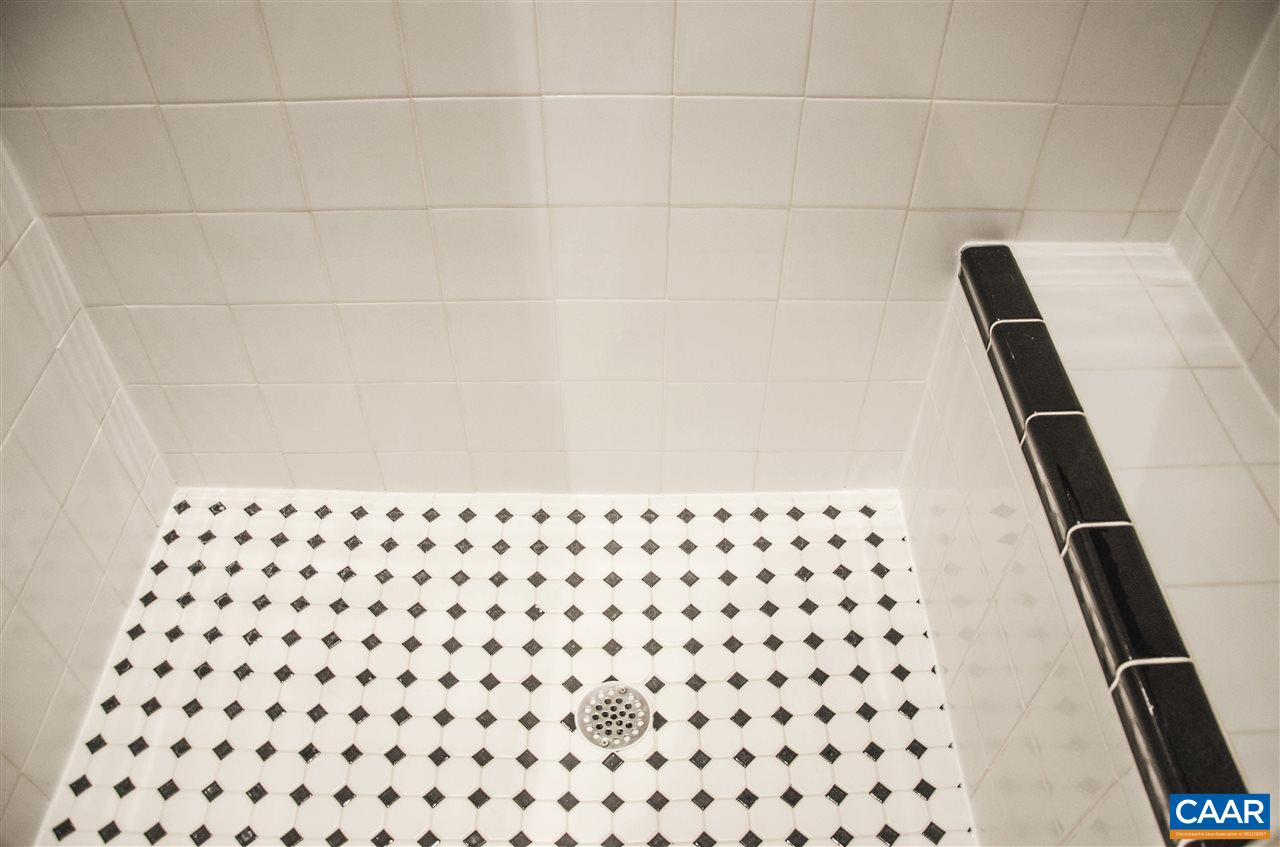 136 Fishpond Road Howardsville, VA 24562 - Photo 23 of 49 a bathroom with a black and white checkered floor