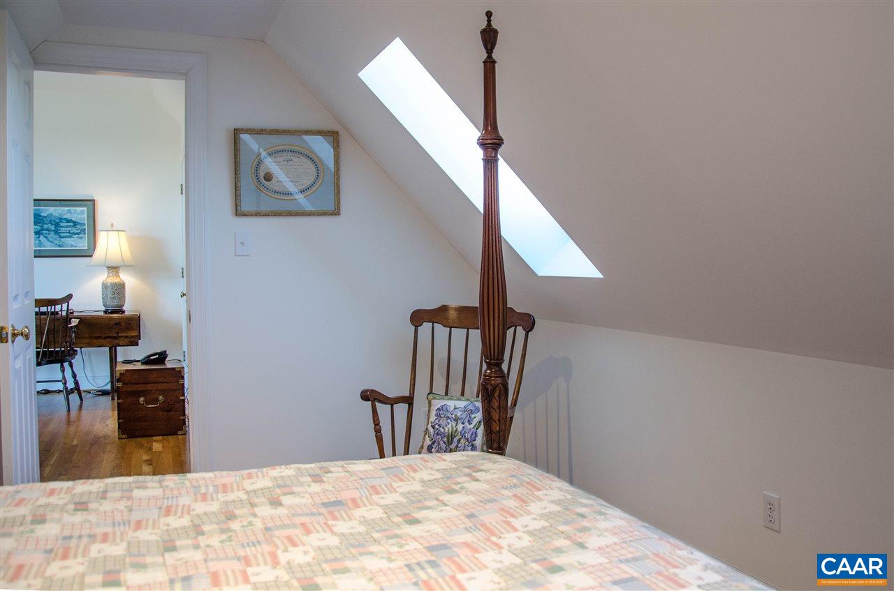 136 Fishpond Road Howardsville, VA 24562 - Photo 32 of 49 a view of a bedroom with wooden floor and chair