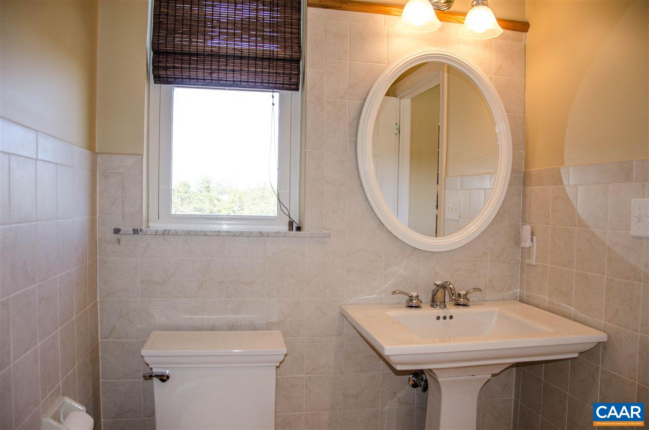 136 Fishpond Road Howardsville, VA 24562 - Photo 36 of 49 a bathroom with a sink a mirror and a toilet