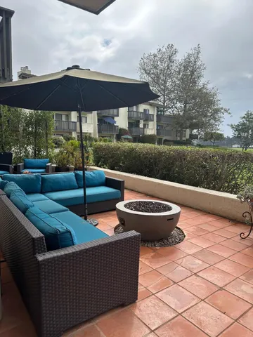 a view of a patio with couches under an umbrella