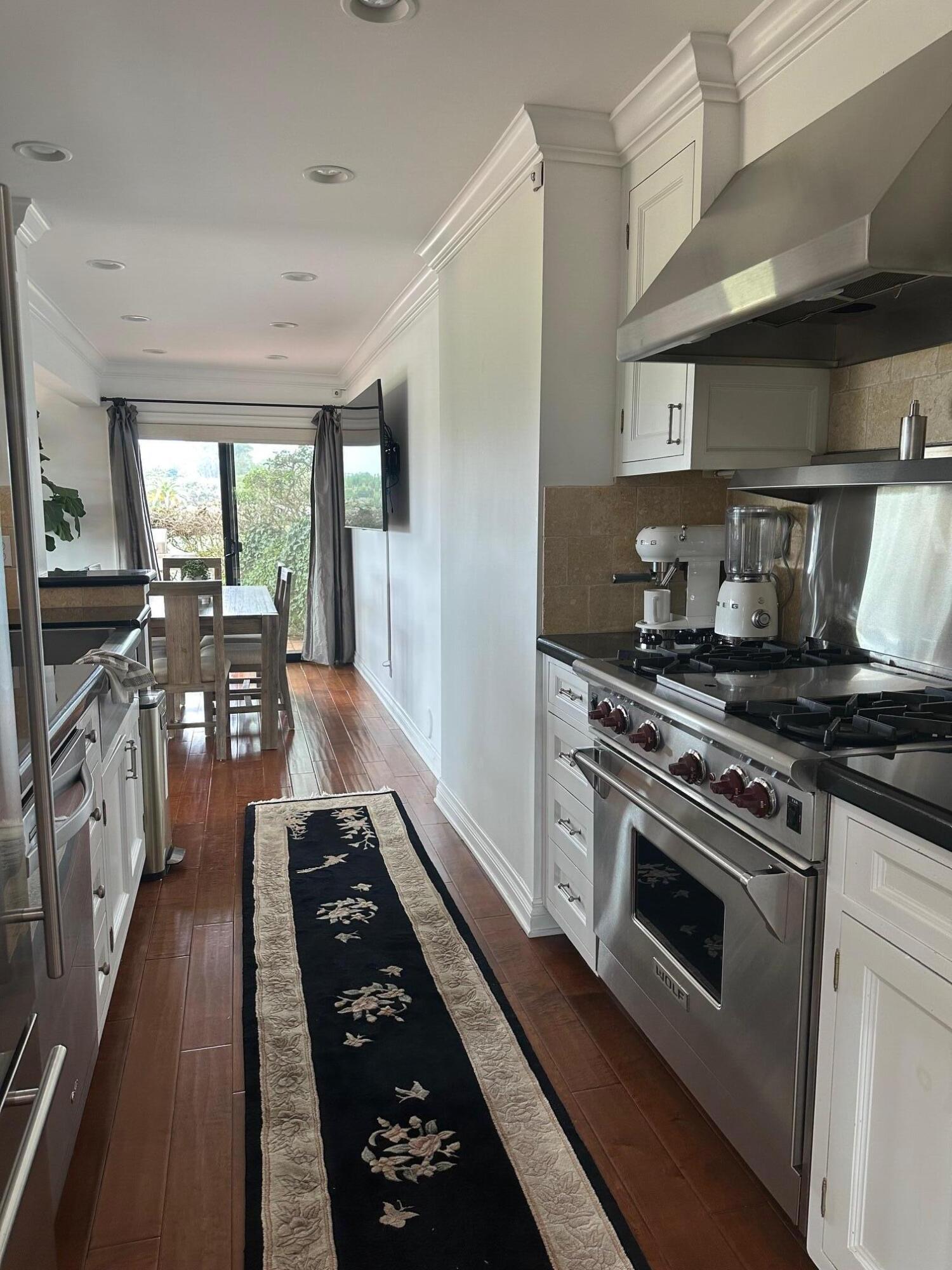3375 Foothill Road, Unit 1114 Carpinteria, CA 93013 - Photo 6 of 17 a kitchen with stainless steel appliances granite countertop a stove a sink dishwasher and a refrigerator