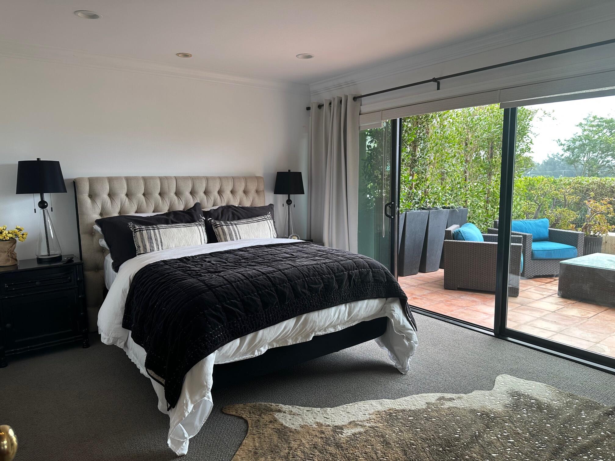 3375 Foothill Road, Unit 1114 Carpinteria, CA 93013 - Photo 7 of 17 a bedroom with a bed lamp and large window