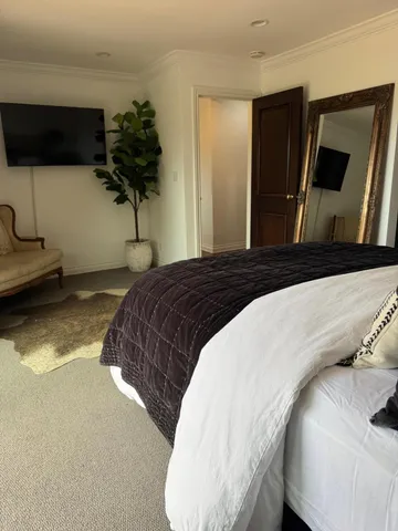 a bedroom with a bed and a flat screen tv