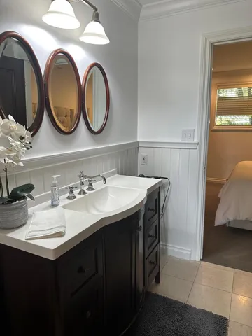 a bathroom with a double vanity sink and a large mirror