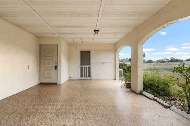a view of a big room with windows and chandelier