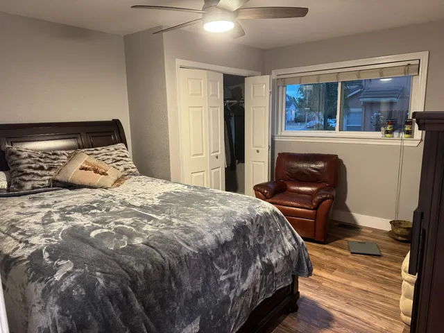 a bedroom with a bed and a view of kitchen