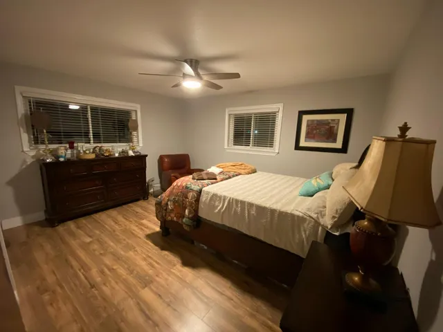 a bedroom with a bed and wooden floor