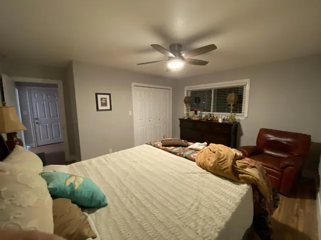 a bedroom with furniture and wooden floor