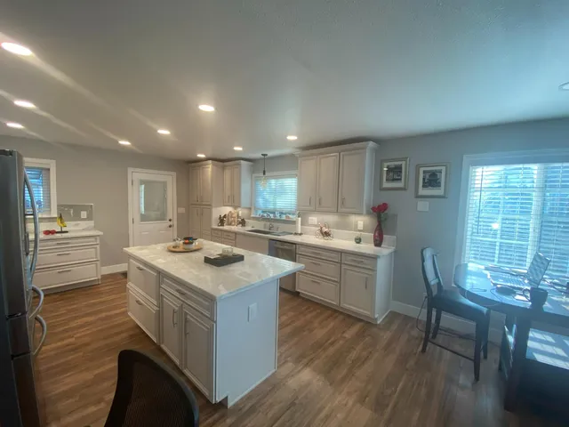 a room with furniture a flat screen tv and a window