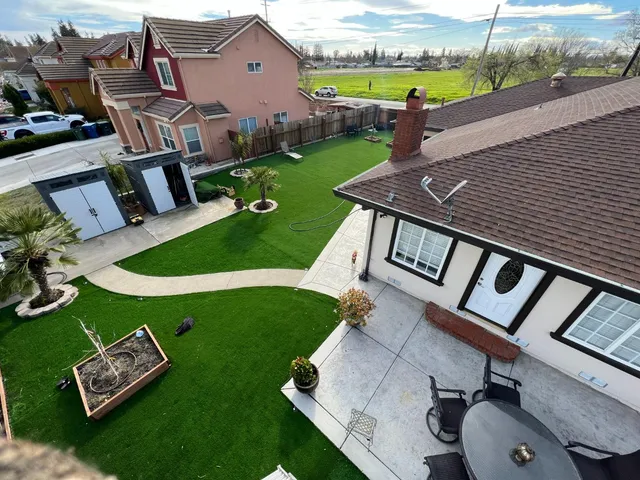 an aerial view of a house with garden space and street view