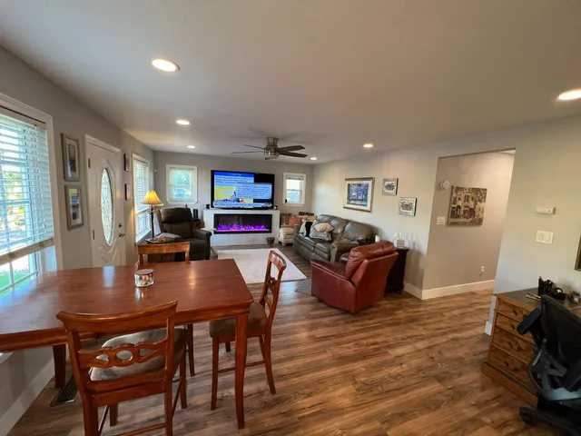 a living room with furniture a table and a flat screen tv