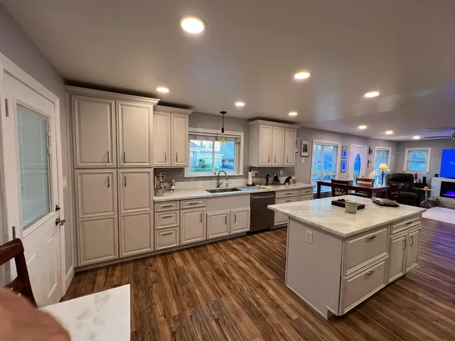 a kitchen with white cabinets sink and white appliances