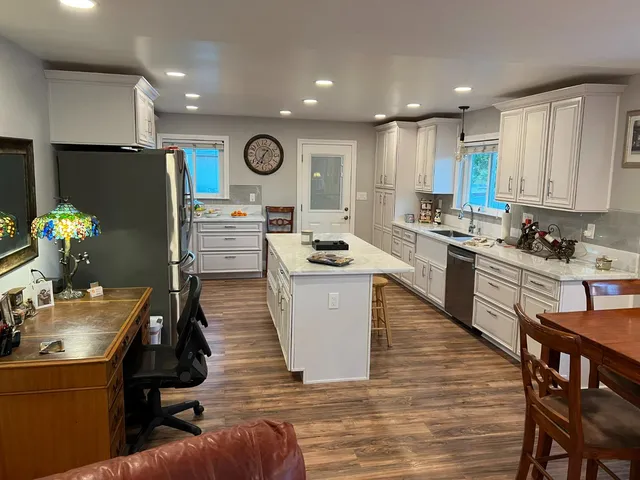 a kitchen with a sink appliances and cabinets