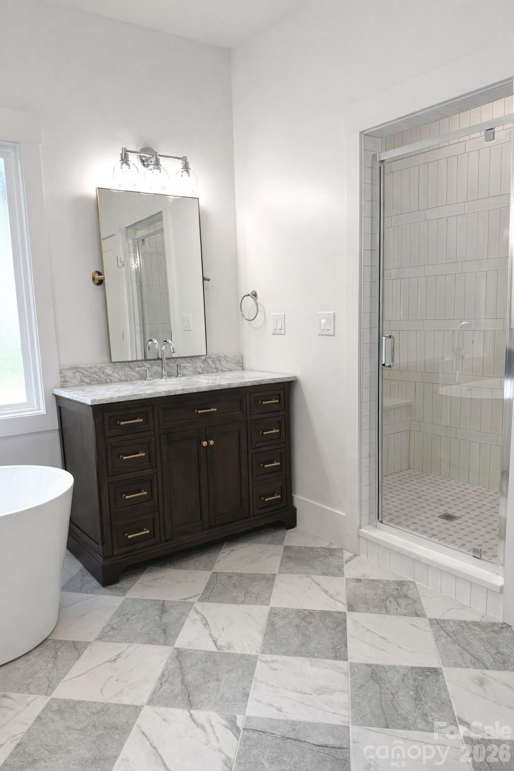 5135 Star Magnolia Court Clover, SC 29710 - Photo 12 of 39 a bathroom with a tub a sink and mirror