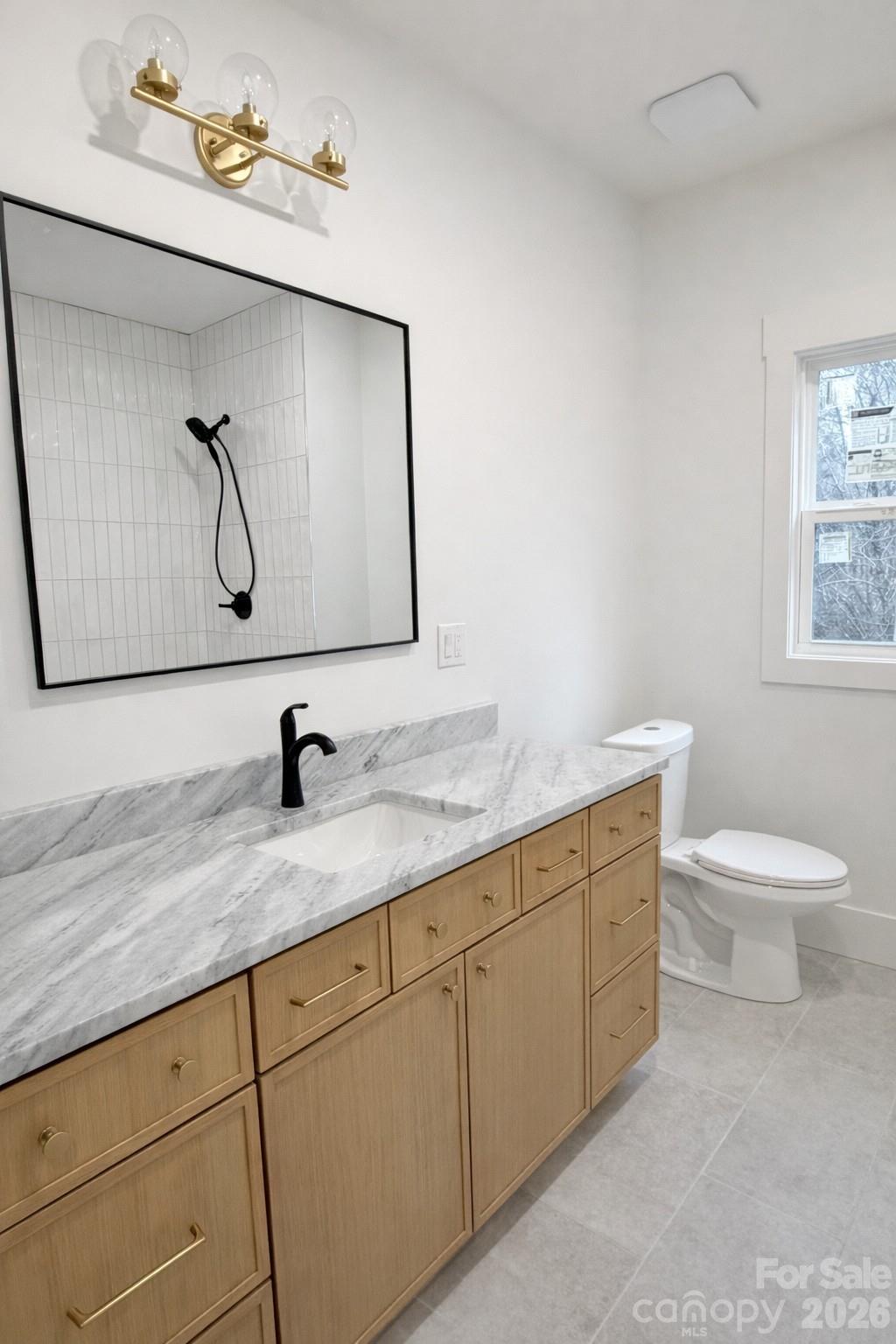 5135 Star Magnolia Court Clover, SC 29710 - Photo 15 of 39 a bathroom with a granite countertop sink a toilet and mirror