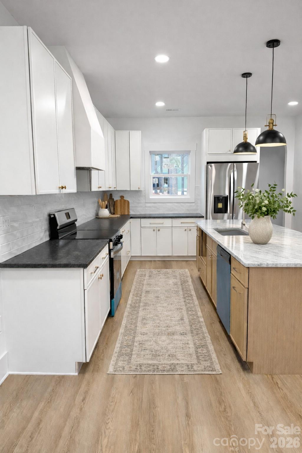 5135 Star Magnolia Court Clover, SC 29710 - Photo 21 of 39 a large white kitchen with stainless steel appliances granite countertop a stove and a sink