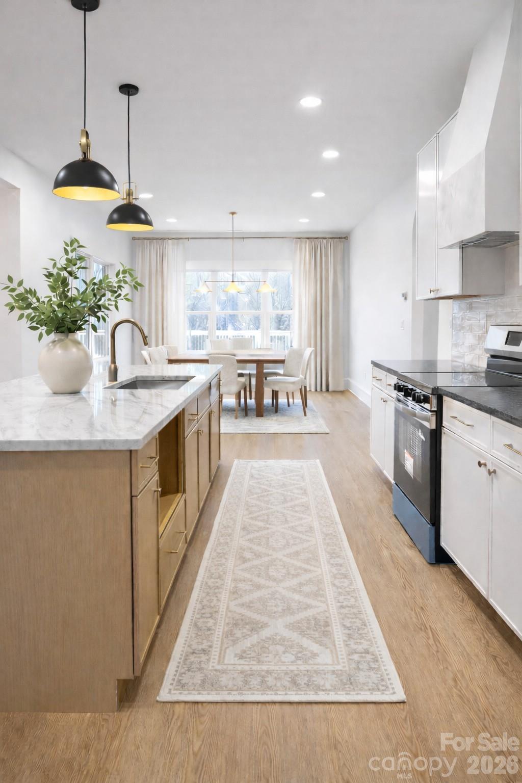 5135 Star Magnolia Court Clover, SC 29710 - Photo 4 of 39 a kitchen with stainless steel appliances granite countertop a sink a stove and a wooden floors