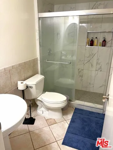 a bathroom with a toilet and a shower