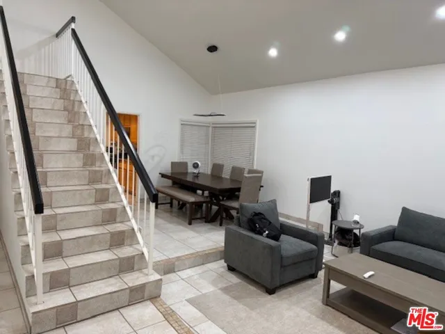 a living room with furniture and stairs