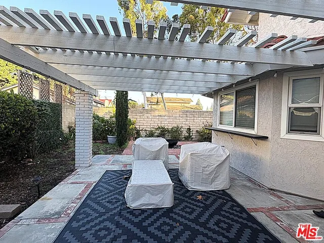 a outdoor space with the couches and dining table with the garden view
