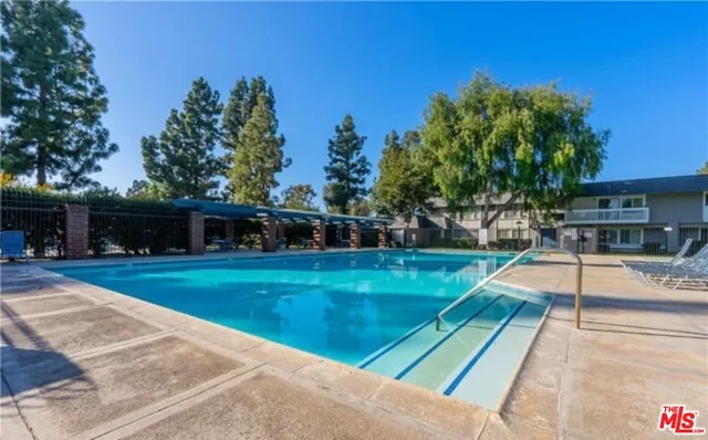 a view of a patio with a table and chairs under an umbrella