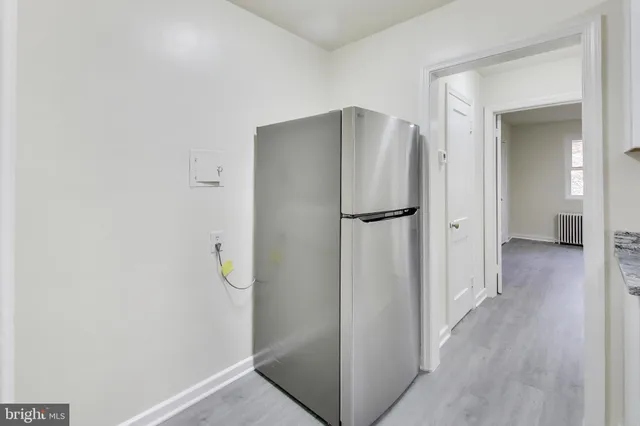 a view of a hallway with wooden floor and a hallway