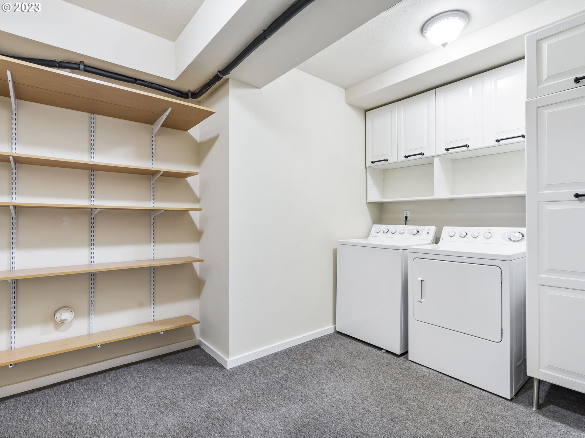 2265 Northwest Miller Road Portland, OR 97229 - Photo 23 of 31 a utility room with cabinets washer and dryer