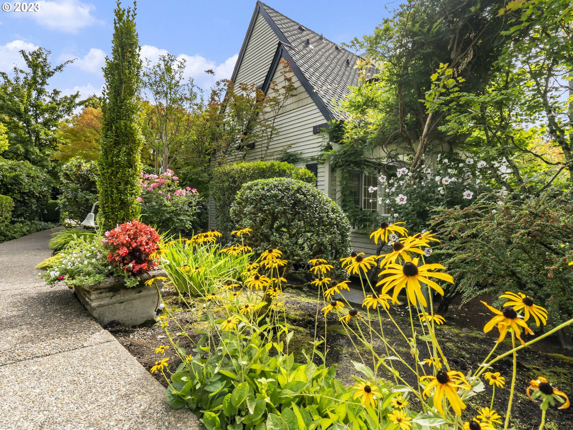 2265 Northwest Miller Road Portland, OR 97229 - Photo 27 of 31 a backyard of a house with a yard and flowers