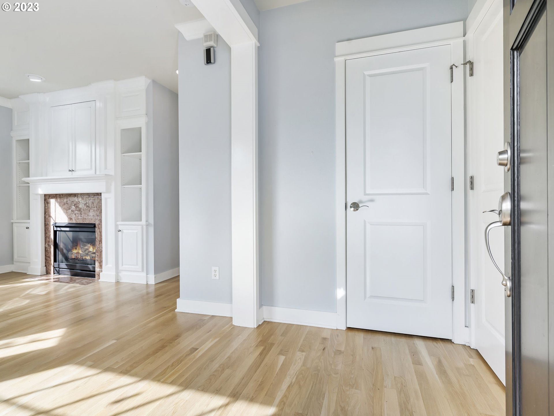 2265 Northwest Miller Road Portland, OR 97229 - Photo 3 of 31 a view of an empty room with wooden floor and a window